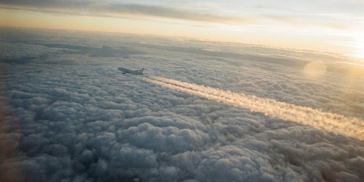 An airliner above the clouds at sunrise